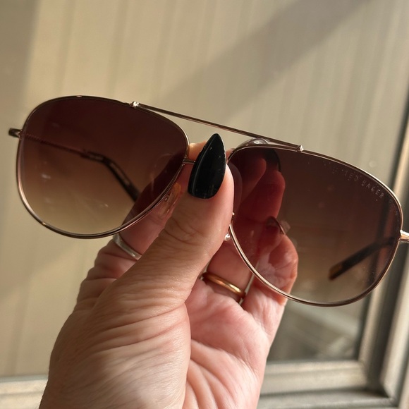 Ted Baker Dark Brown Sunglasses with floral detail sides.